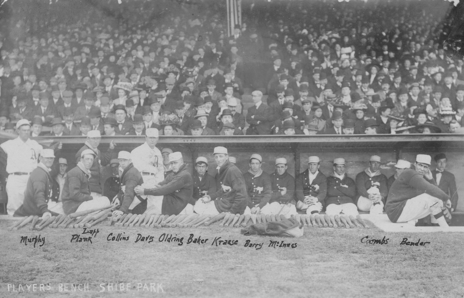 Athletics players relax in their dugout just before the start of the inaugural home opener at Shibe Park on April 12, 1909.