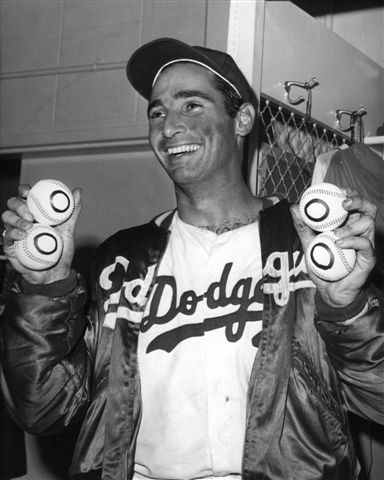 Sandy Koufax, center, of the Dodgers is rushed by teammates as he leaves  the mound after pitching a perfect game, no batter reached first, against  the Chicago Cubs, Sept. 10, 1965, Los