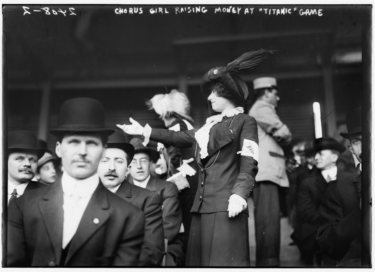 At the 1912 Titanic exhibition game, two members of the Female Giants—a women’s baseball team with connections to the New York Giants—roam the aisles to request donations to assist the Titanic’s survivors.