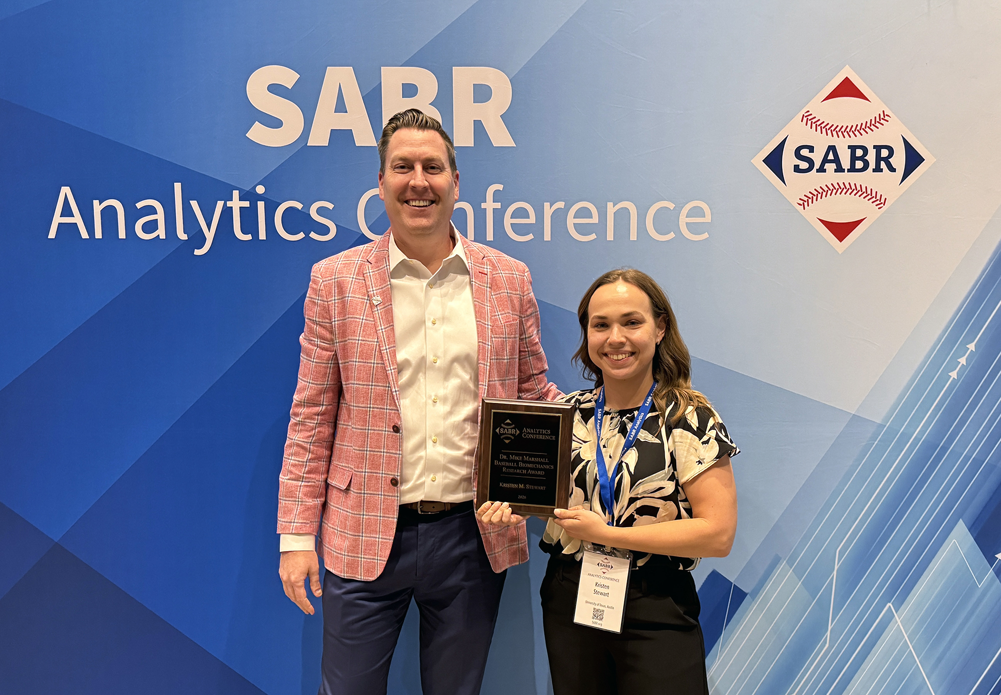 Kristen M. Stewart, right, was announced as the winner of the 2026 Dr. Mike Marshall Baseball Biomechanics Research Award on February 28, 2026, at the SABR Analytics Conference in Phoenix, Arizona. She was presented with the award by SABR CEO Scott Bush.